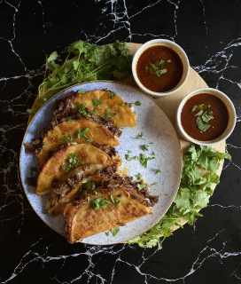 Photo of Beef Birria Tacos with broth for dipping