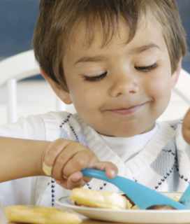 Image of small child eating. Alameda County Community Food Bank Needs Your Help