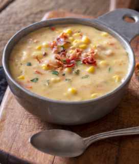 Image of a bowl of corn chowder garnished with bacon
