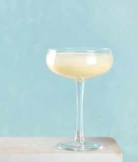 Image of Sweet Corn Cocktail on a table against a blue background