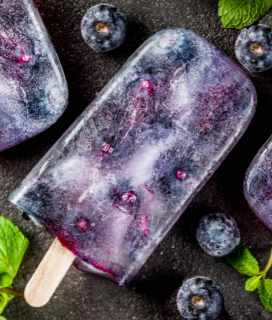 Photo of Blueberry Mojito Popsicles against a dark background