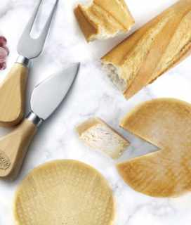 Image of Miyoko's Creamery Farmhouse Cheddar on a board with a baguette