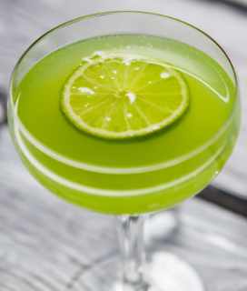 Photo of a bright-green Gin Rocket on a wooden table