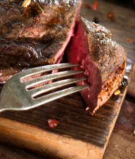Image of Reverse Searing Steaks on a woodend cutting board