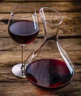Image of a glass of Chianti with decanter on a table top