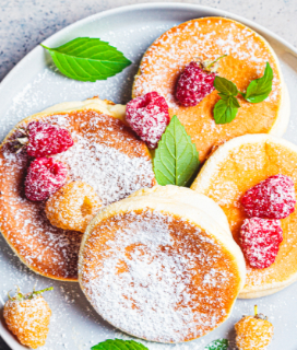 Japanese Soufflé Pancakes with raspberries and powdered sugar