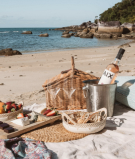 A picnic on the beach with a bottle of AIX Rosé 2021