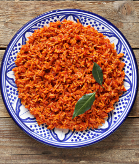Photo of a dish of Jollof Rice on a wooden table