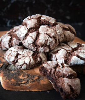 A photo of Classic Chocolate Crinkles on a wooden board