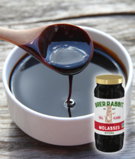 Brer Rabbit Molasses in a bowl with a wooden spoon