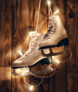 A pair if figure skates hung with christmas lights for 2023 Holiday Ice Skating