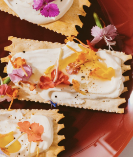Photo of La Panzanella Artisanal Croccantini with cream cheese and edible flowers. 